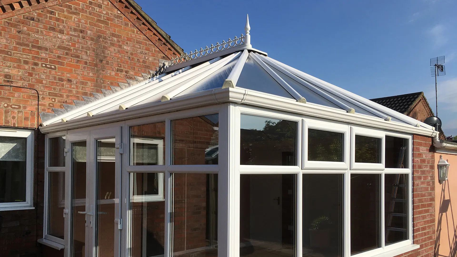 A fully cleaned white uPVC conservatory with a sparkling glass roof in Parson Drove, serviced by Crystal Clean Windows.