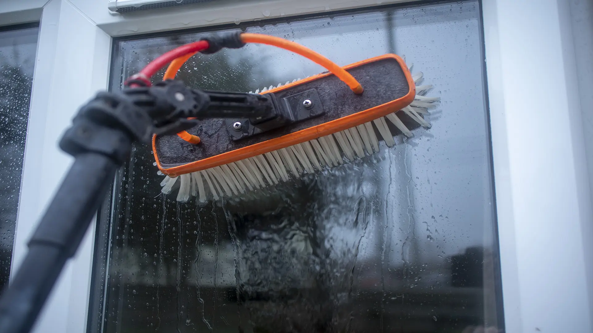 Professional window cleaning service using a Xline systems water-fed pole system on a residential glass windowin wisbech Parson Drove.